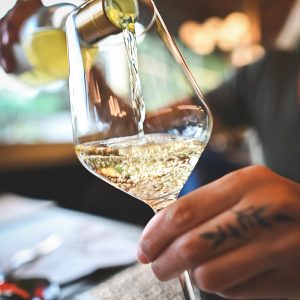 Sommelier pouring champagne into tasting glass