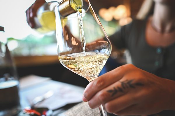 Sommelier pouring champagne into tasting glass