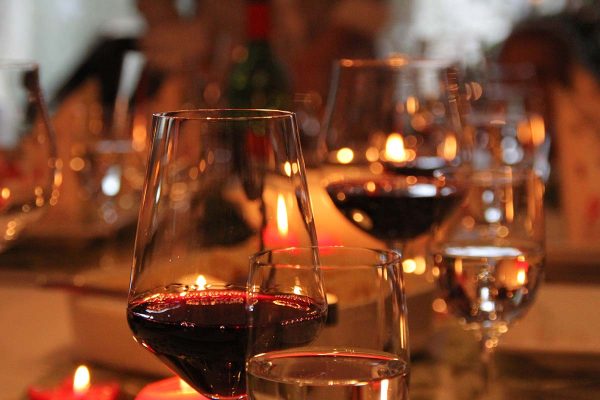 Candlelit table with filled wine glasses